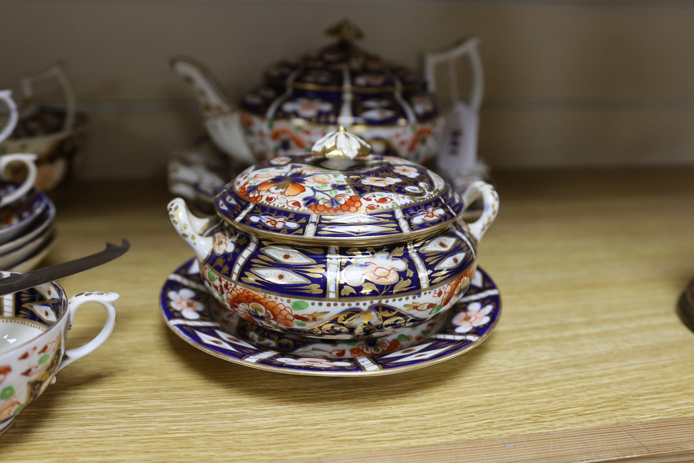 A mid 19th century Derby Imari pattern tea service, comprising a pair of two handled cake plates, a teapot on stand, a sucrier, a cream jug, a bowl and cover, three cups and four saucers, NB: From the Estate of Rt Hon Lo